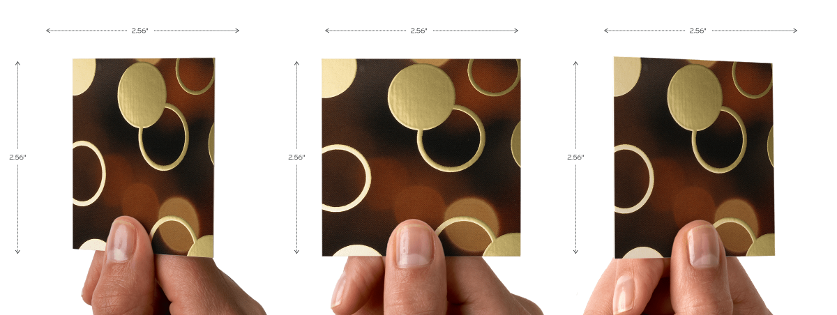 Hand holding gold foil square business card at different angles