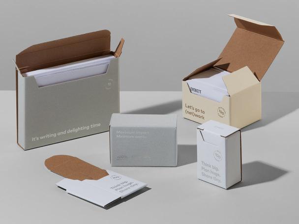 MOO's sustainable packaging including postcard boxes, business card boxes and a flattened cardboard box