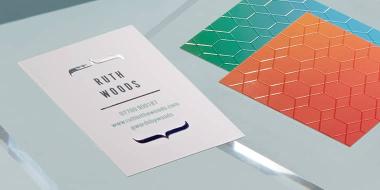 Business cards with spot UV gloss details in various sizes, formats and designs on light gray background