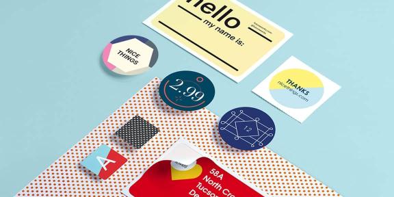 Yellow name tag, round stickers, mini rounded square stickers & red address label on red dots sheet & light blue background