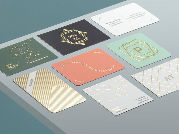 8 high-quality Gold Foil Business Cards in various sizes, shapes and designs on grey background 