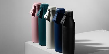 5 insulated water bottles in different colours, including pink, green, white, dark blue and black water bottles