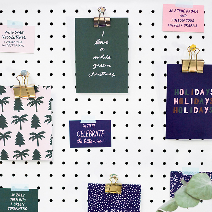 Melanie Johnsson green and blue holiday cards on wall