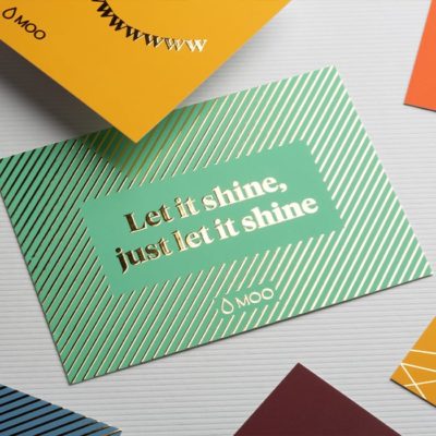 MOO business card design using gold foil material, reading "Let it shine, just let it shine"