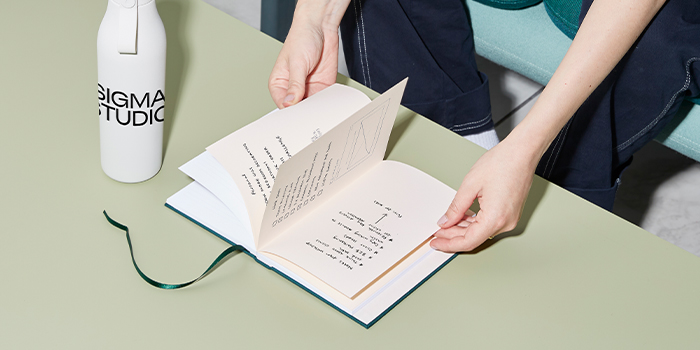 Person going through a dotted Hardcover Notebook.