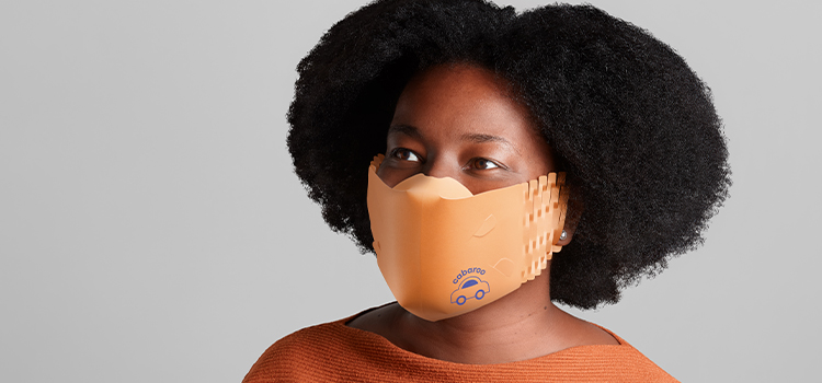 woman wearing an orange custom face mask made of recycled paper