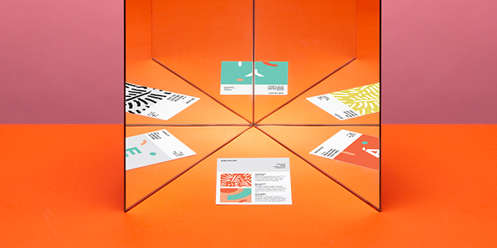 Mirror reflecting different creative print materials to tell a consistent brand story