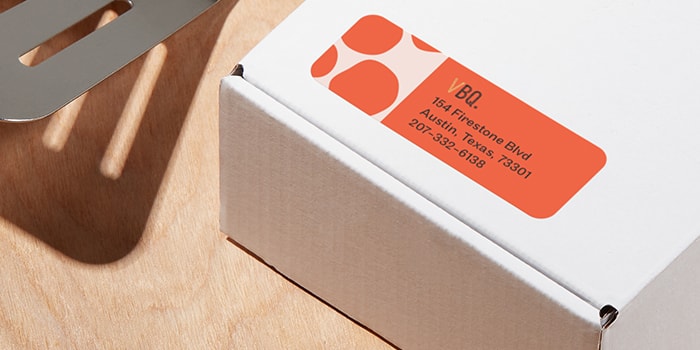 Return address label with orange design on package