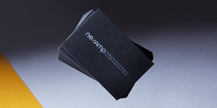 Stack of Nexamp business cards made on recycled cotton