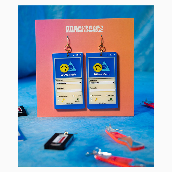 Floppy disks acrylic earrings by Mackbecks on their orange backing card