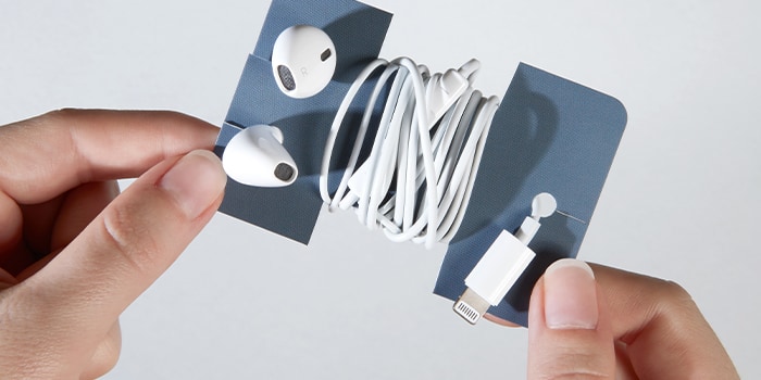 Business card used as an earphone holder with earphones wrapped around it