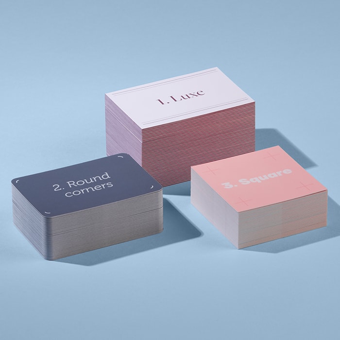 3 stacks of business cards. The biggest one says Luxe, the second bigger is rounded corners and the third one is square business cards