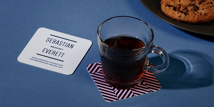 Espresso cup on a square business card used as a coaster
