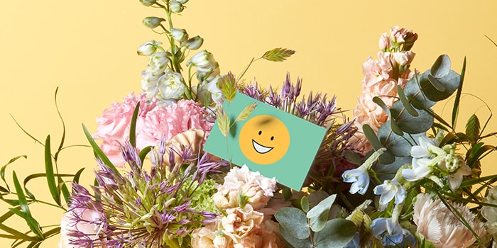 Smiling emoji card in flower bouquet