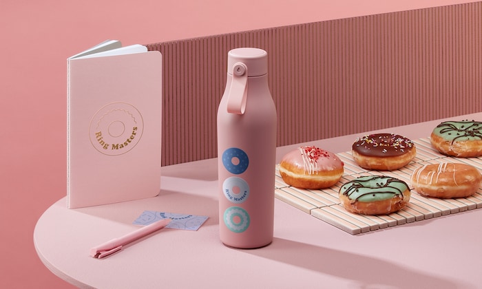 Pink notebook, water bottle and doughnuts