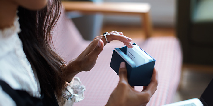 MOO business cards being looked at by a customer