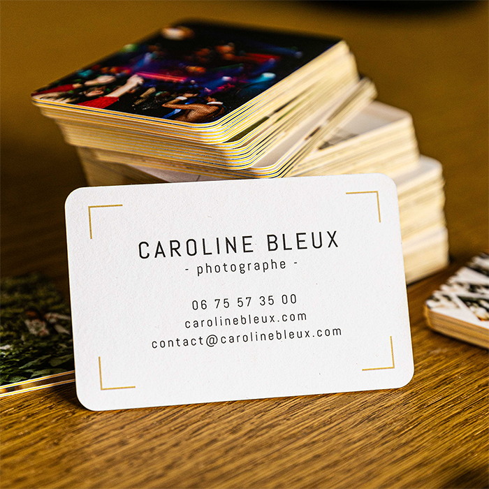 Caroline's Business Card resting against a pile of Business Cards.