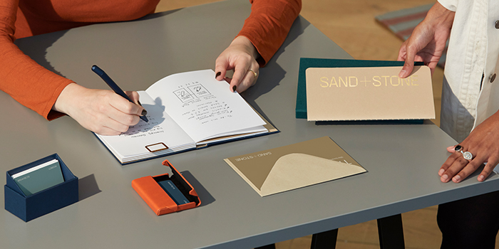 MOOsters working together and using branded corporate gifts, such as Notebook and Soft Cover Journal.