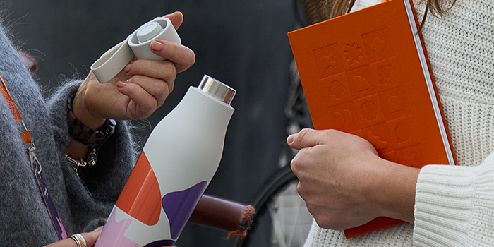 Attendees holding their branded merch.