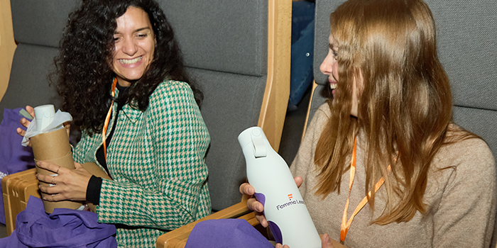 Attendees unboxing water bottles.