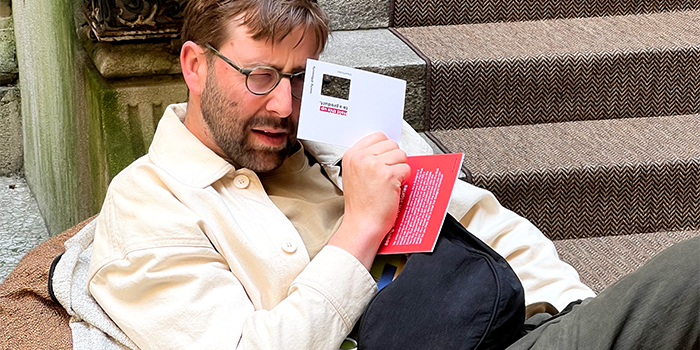 Event attendee interacting with Postcard cue card.