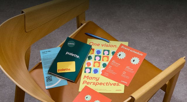A selection of printed marketing materials and branded merchandise on a chair