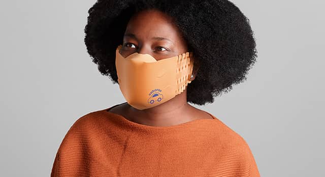 Woman wearing a custom face mask made of orange recycled paper