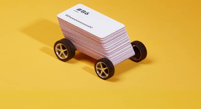 Pile of mini business cards on wheels to look like a delivery van