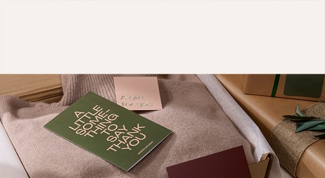 A selection of printed marketing materials and branded merchandise on a chair