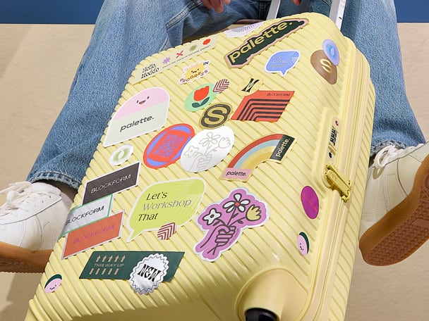 Mosaic of multicolored sticker sheets in various shapes and designs on a gray background