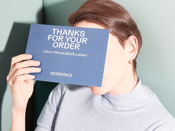 Woman holding a Postcard