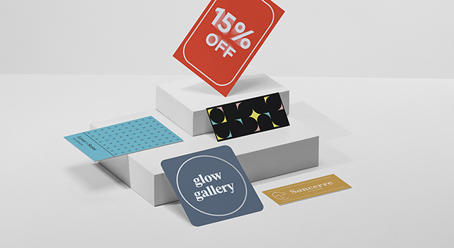 A range of business cards in different sizes displaying 15% off and discount code.