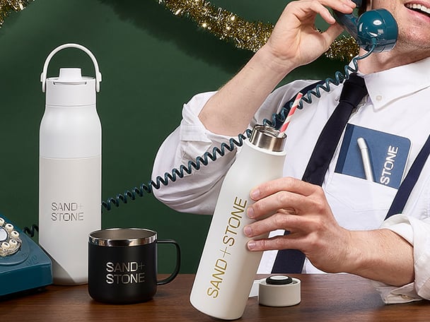 A person on the telephone surrounded by custom gifts and print