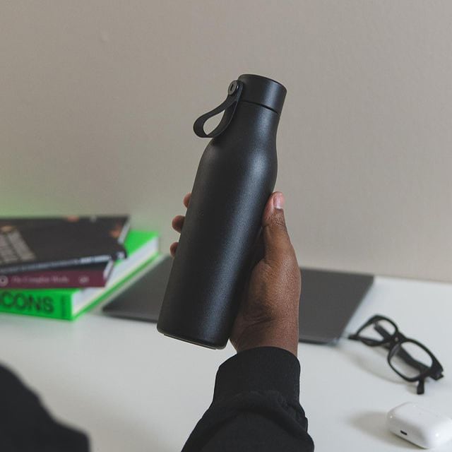 Hand holding a black Water Bottle