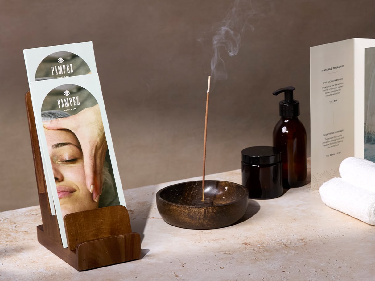Gloss brochures positioned amongst spa items including a burning incense