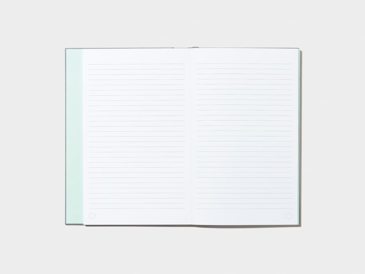 An opened Charcoal Grey Hardcover Notebook with lined pages 