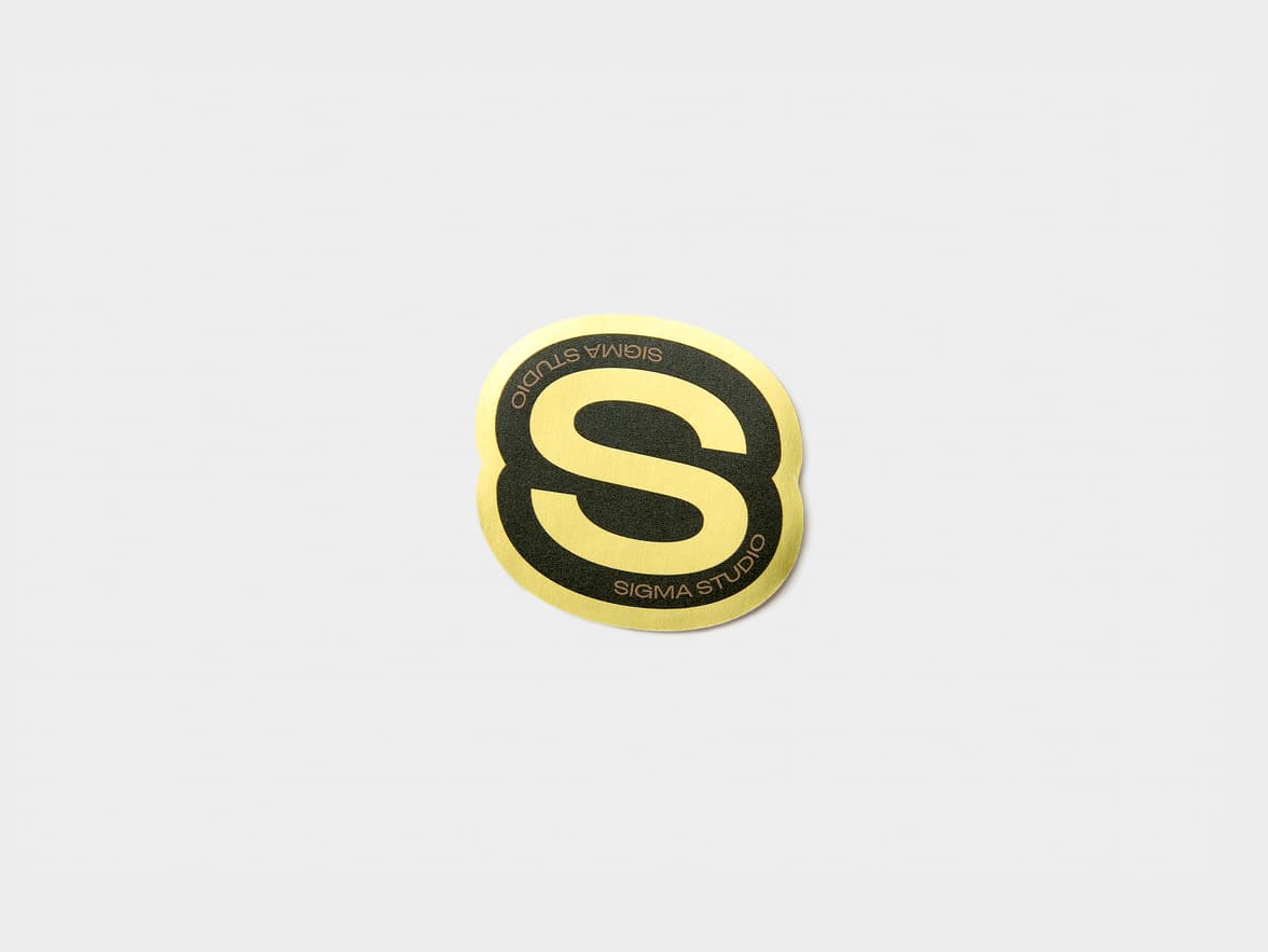 A gold metallic sticker customized to be in the shape of a bold S.