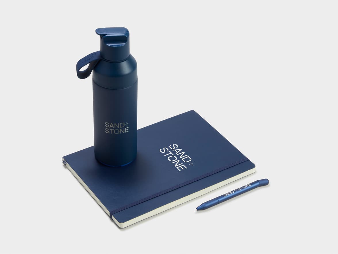 Collection shot of the Navy LEUCHTTURM1917 Classic Softcover Composition Notebooks with a Water Bottle and a Pen