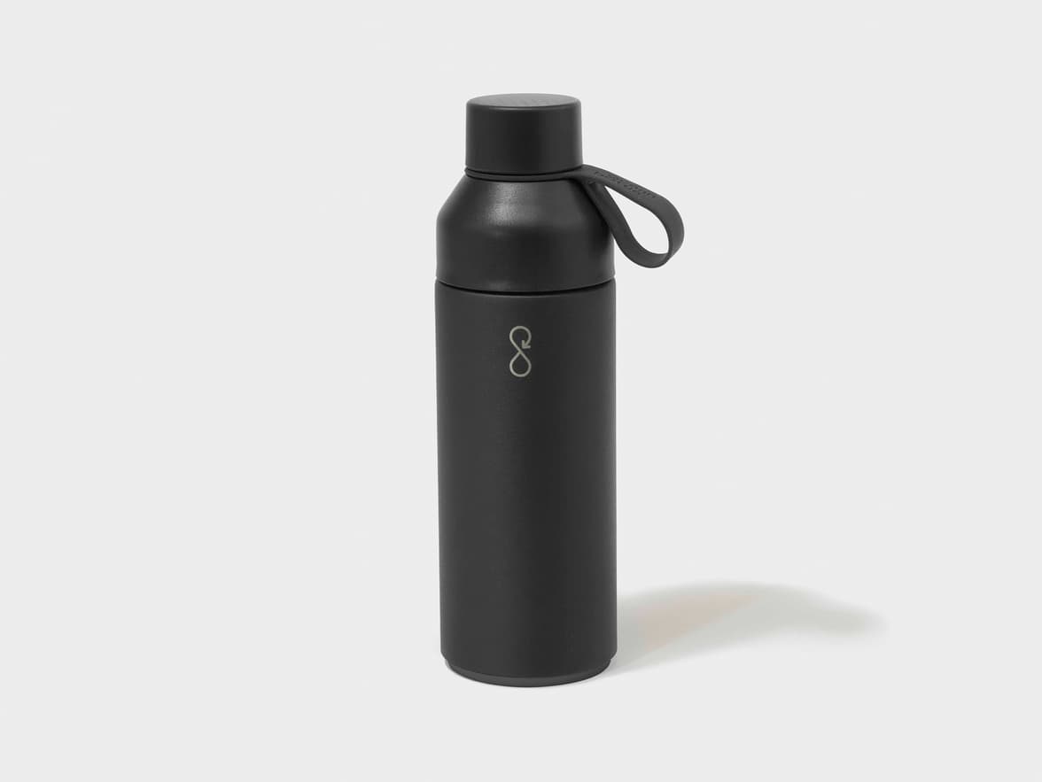 A black matte Ocean Bottle with a black lid and carrying loop.