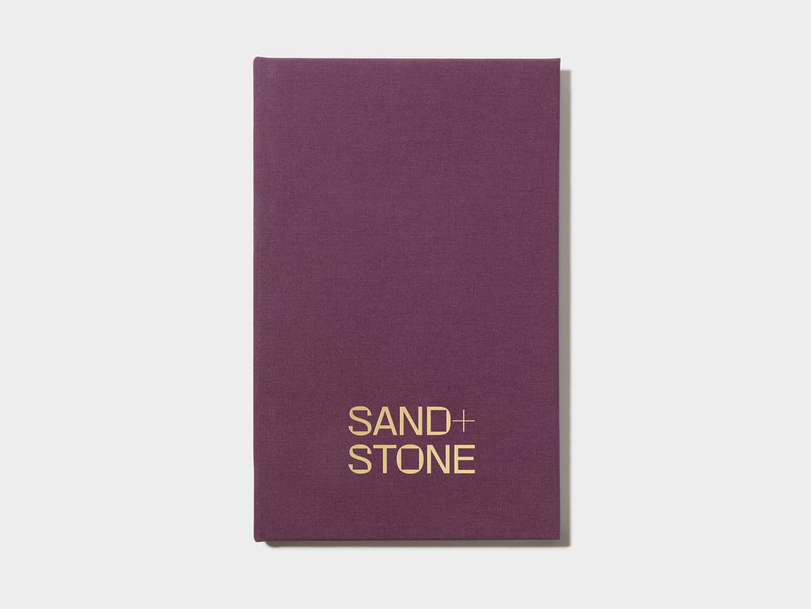A mulberry coloured hardcover notebook with gold foil customisation on the front.