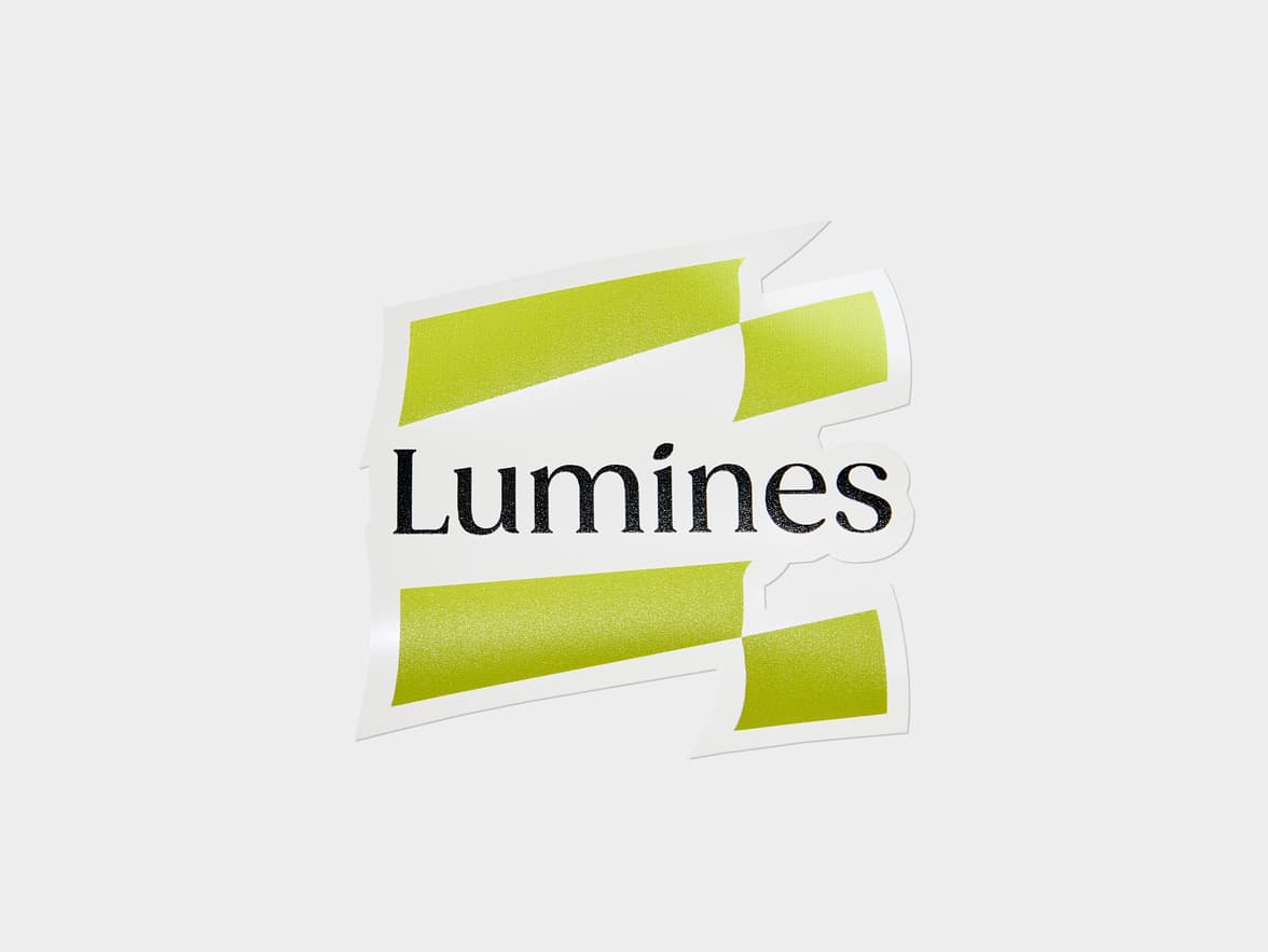 A customized clear die cut sticker with the colour lime green and the word 'Lumines' printed on it.