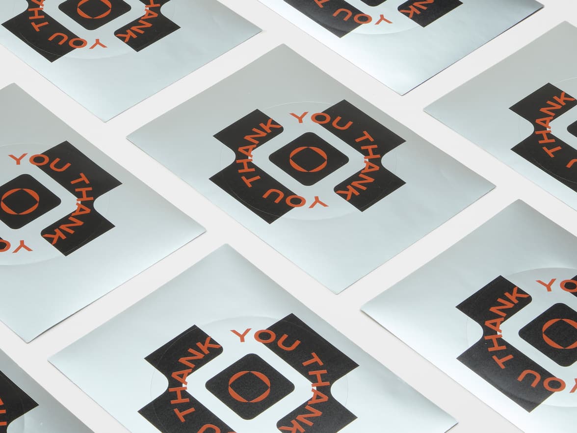 A collection of large round silver metallic stickers.