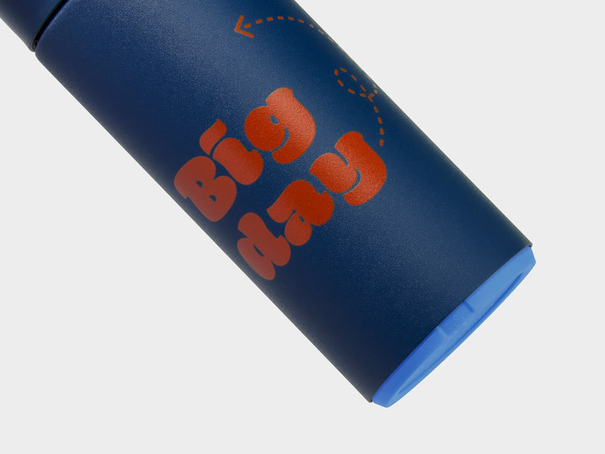 A navy blue bottle with the words "Big Happy" in orange.