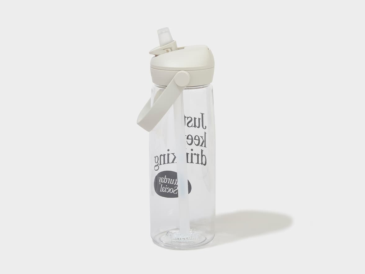 Clear water bottle with a beige lid, handle, and straw, branded with 'Just Keep Dripping Sunday Social'.