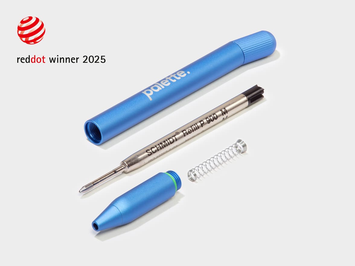 A dismantled light blue MOO Twist Pen with a red dot design award logo in the top left corner.
