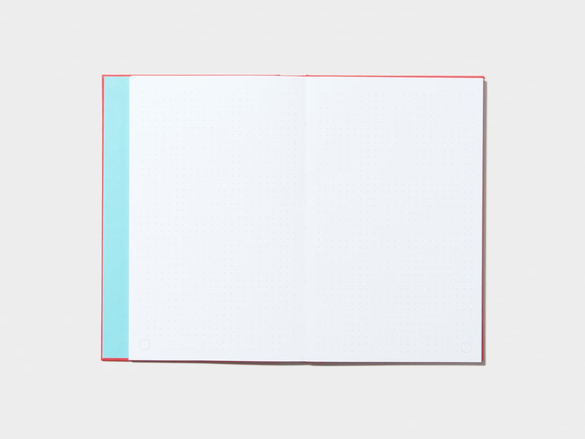 An opened Berry Red Hardcover Notebook with dotted pages 