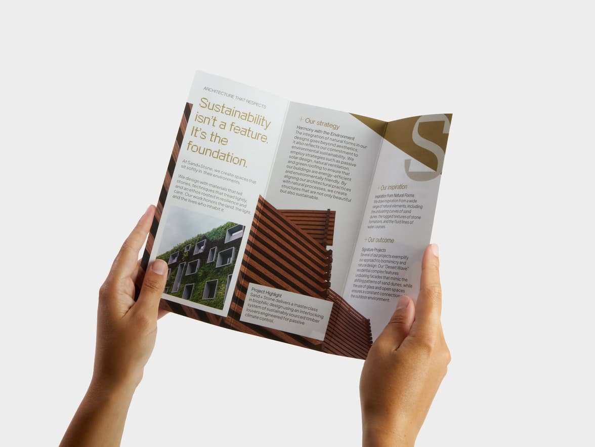 A pair of hands holding open a Tri-Fold Super Brochure.