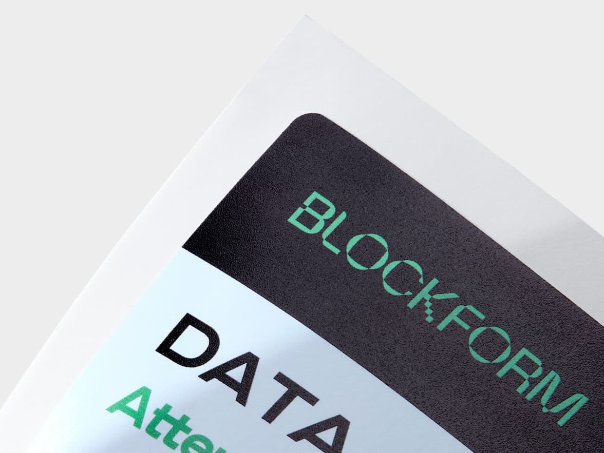 A close up image of the corner of a customized rectangular coated sticker.