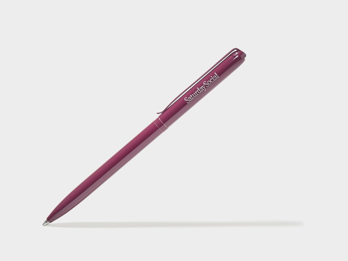 A diagonal mulberry pen with 'SaturdaySocial' branding.