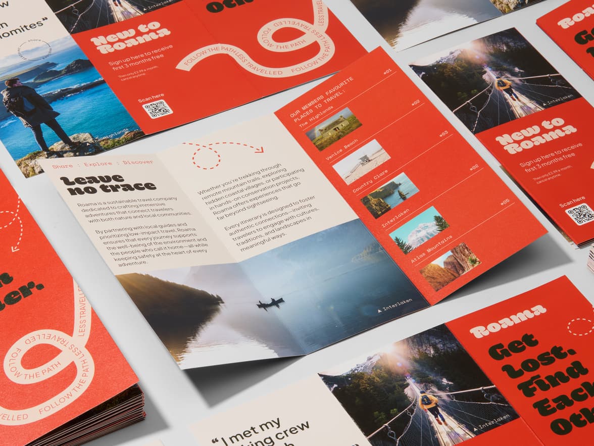 Red and cream "Roama" travel brochures displaying scenic destinations.